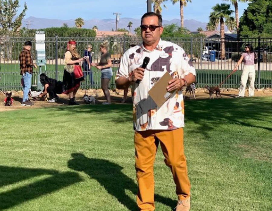 Antonio Baciu speaking to other residents at a Cathedral City event in a Cathedral City dog park.